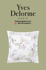 Yves Delorme Orchidée sham with elegant floral embroidery on soft white fabric for luxurious bedroom decor.