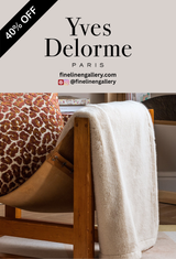 Palais Royal Linen Gallery Frisson throw blanket in soft, textured fabric, displayed draped over a cozy armchair.