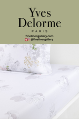 Orchidée fitted sheet by Palais Royal Linen Gallery showing a soft, floral-patterned bed sheet on a neatly made bed.