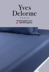 Yves Delorme Apollon duvet cover in Outremer with intricate pattern, shown with fitted sheet, soft fabric and elegant design.