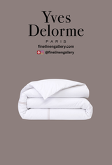 Luxurious Yves Delorme Duo duvet cover in elegant Loutre pattern, displayed on a neatly made bed with soft, high-quality fabric.