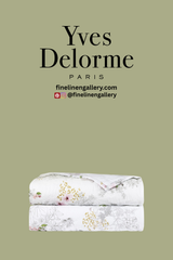 Elegant orchid-patterned coverlet from Palais Royal Linen Gallery, showcasing soft fabric and detailed floral design.