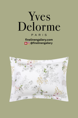 Yves Delorme Orchidée Sham with floral embroidery in soft pastel shades, elegant decorative pillow for luxurious bedroom decor.