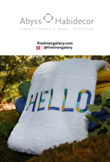 Cream-colored abyss habidecor Hello Towel with embroidered "Hello" text, soft cotton fabric, and striped border.