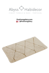 Abyss Habidecor Heritage bath rug with intricate woven pattern in neutral tones on a bathroom floor